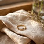 A gold ring resting on linen.